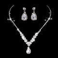 Clear rhinestone teardrop necklace and earrings on a black background