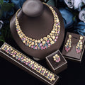 Oversized gold-tone necklace, earrings, bracelet and ring with pastel pink stones on a display bust