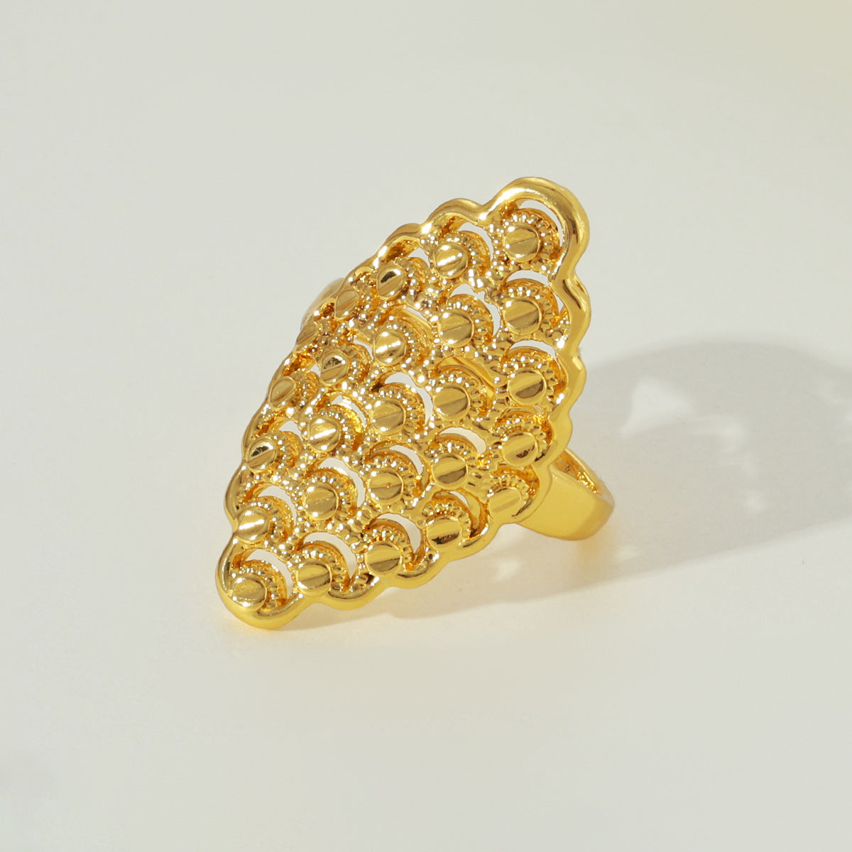 Gold-tone hollow lattice open ring, standing view