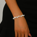 Pearl and rhinestone bracelet worn on the wrist