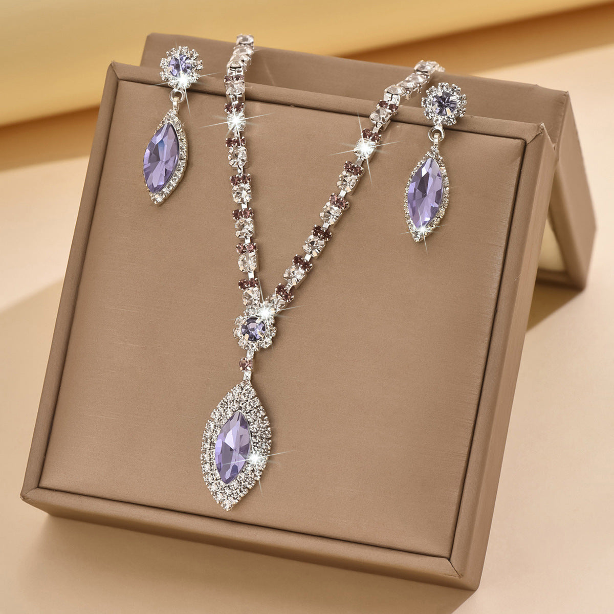 Lavender teardrop rhinestone necklace and earrings in a gift box