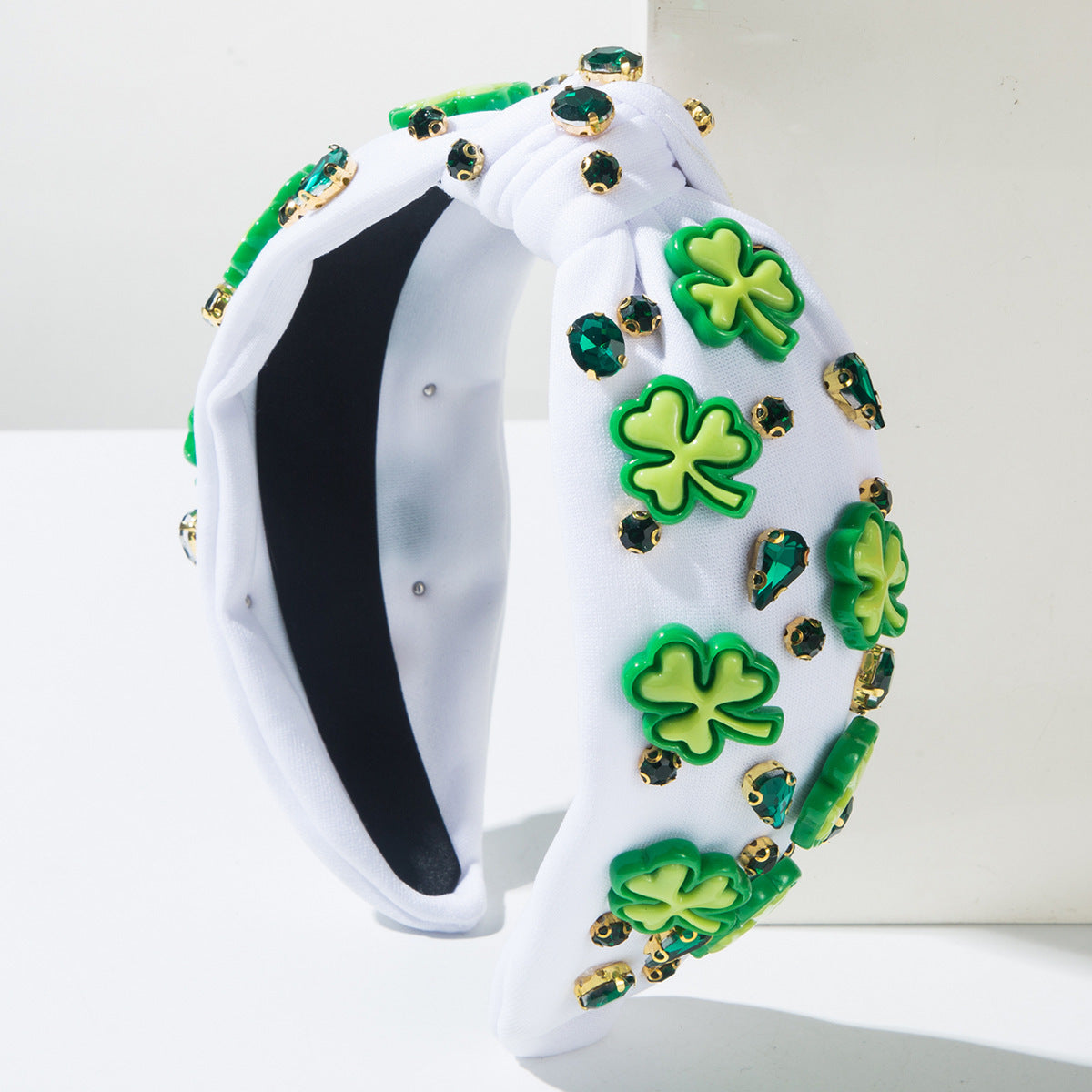 White knotted headband with green shamrock rhinestones