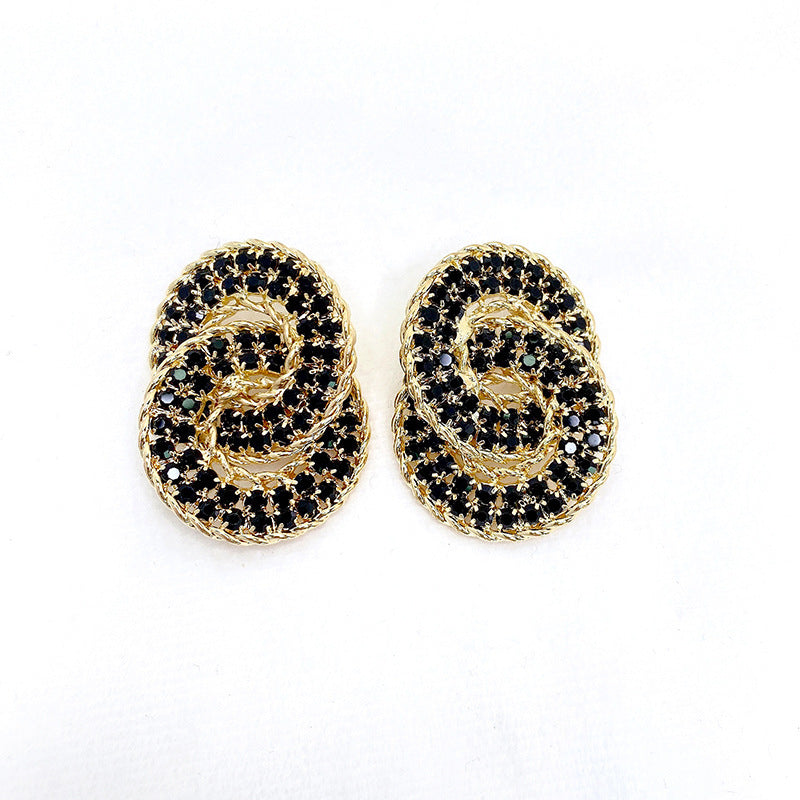 Gold-tone double arc earrings with black rhinestones