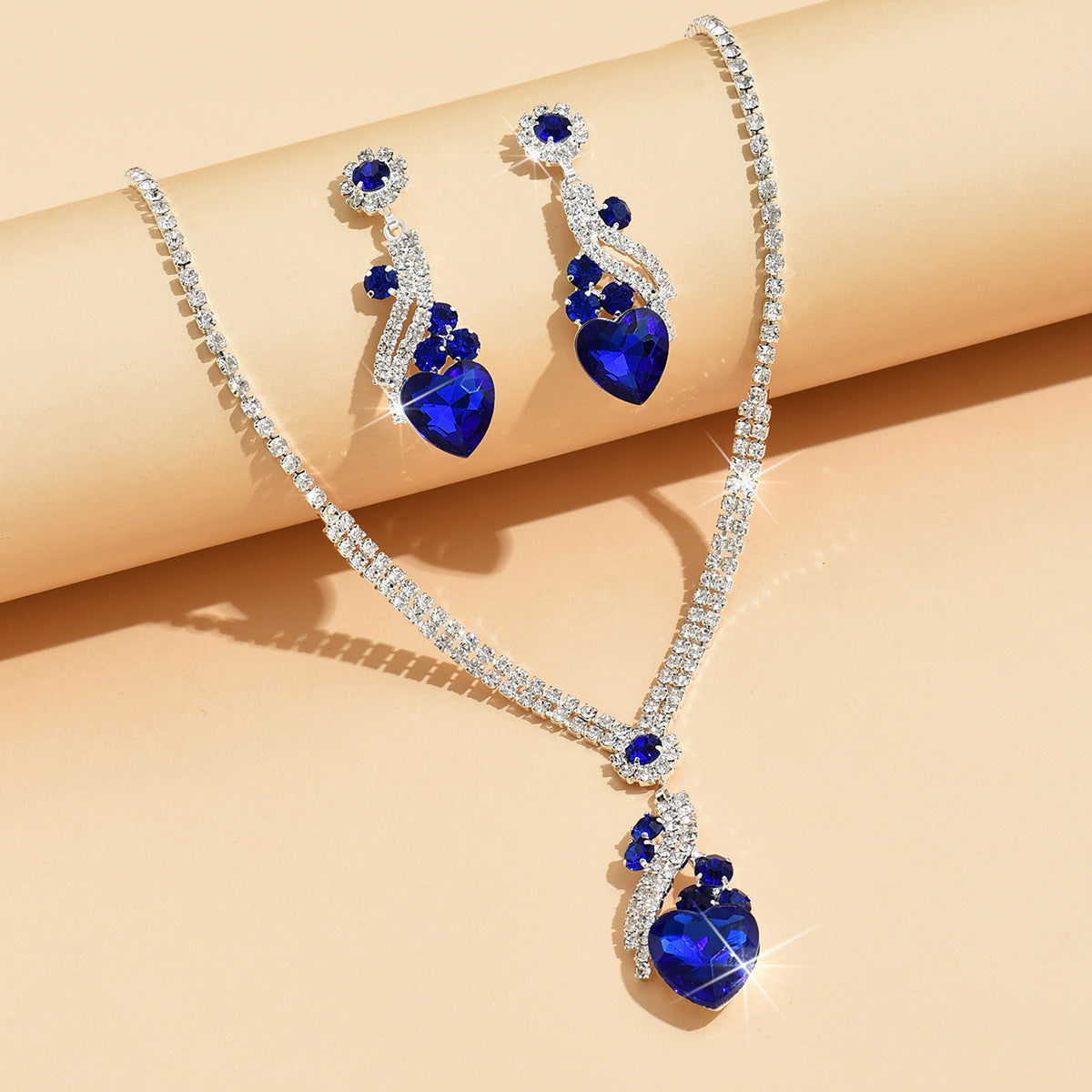 Royal blue claw chain teardrop necklace and earrings laid flat
