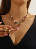 Multicolor zircon leaf necklace and earrings worn by a model