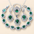 Green cubic zirconia necklace, earrings, ring and bracelet laid flat
