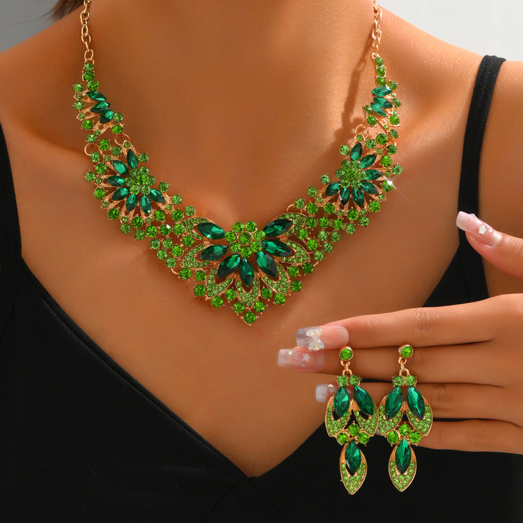 Green stone flower statement necklace and earrings worn by a model