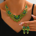 Green stone flower statement necklace and earrings worn by a model