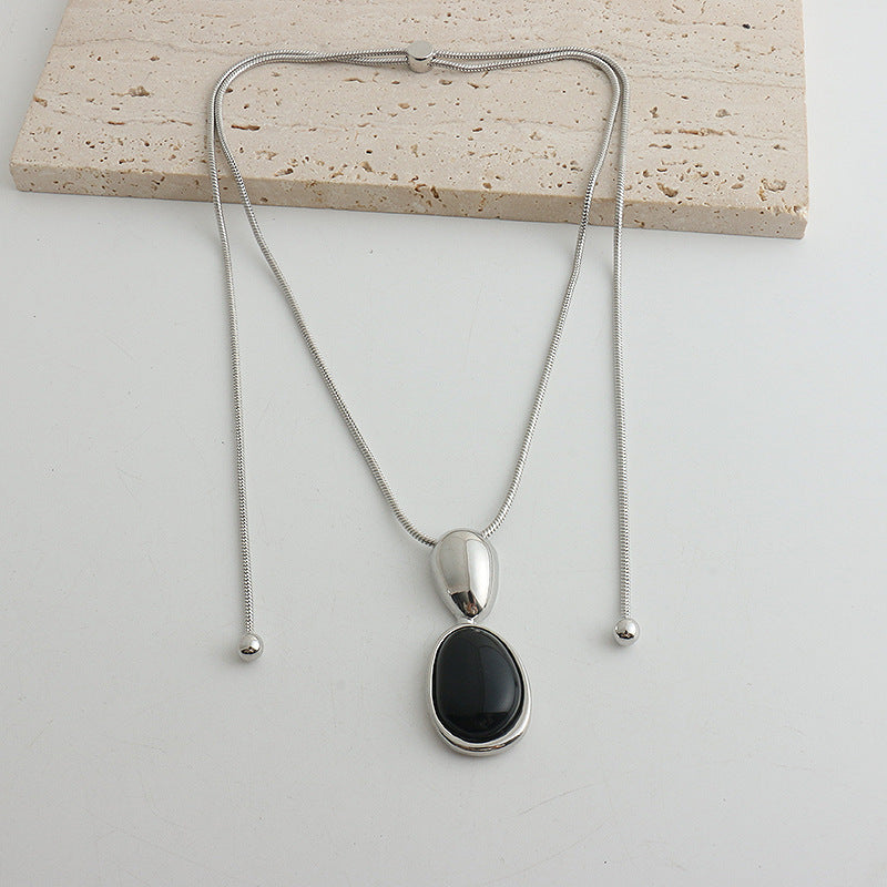 Silver-tone snake chain necklace with black onyx pendant
