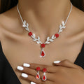 Red flower teardrop necklace and earrings worn by a model