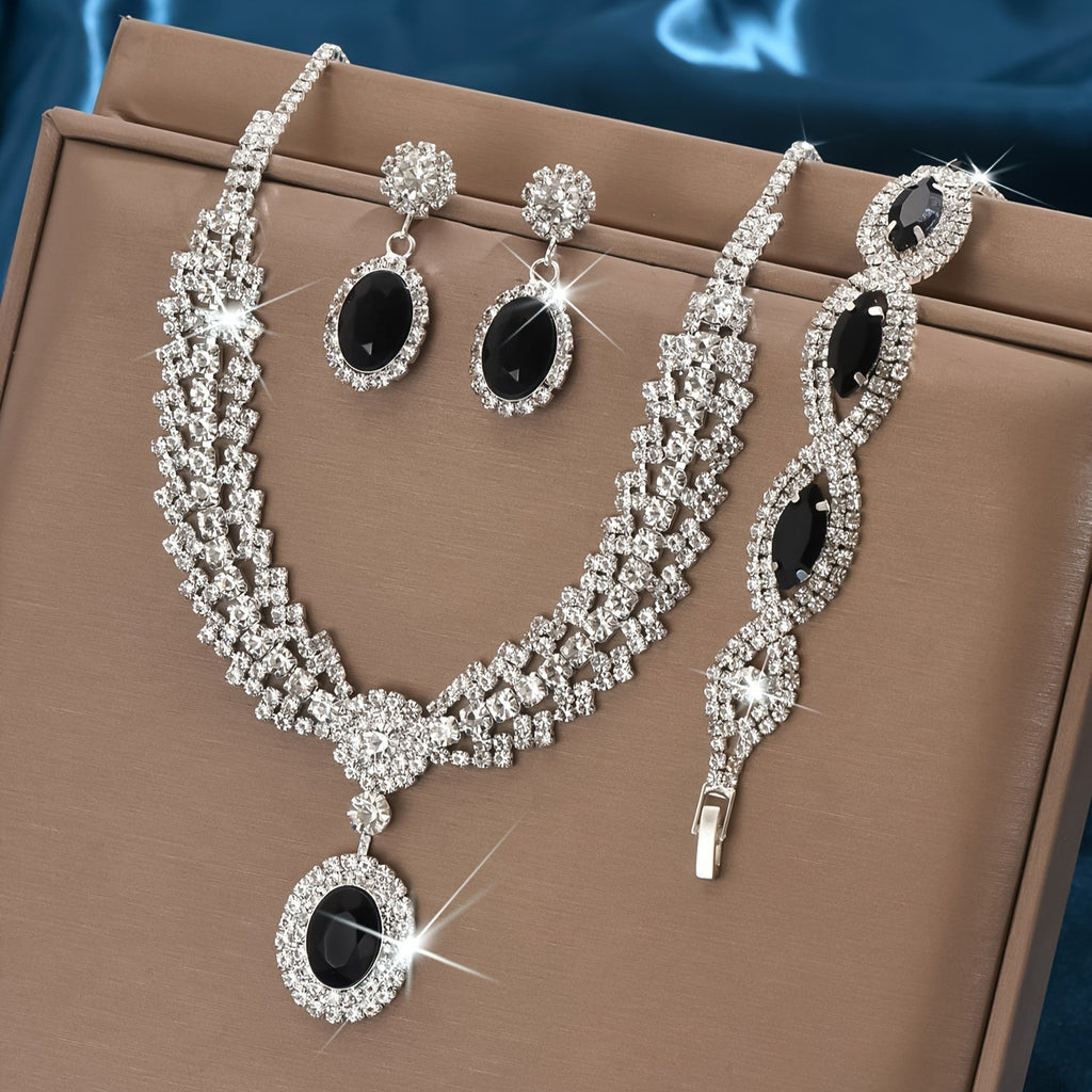 Black stone necklace, earrings and bracelet set on a brown display